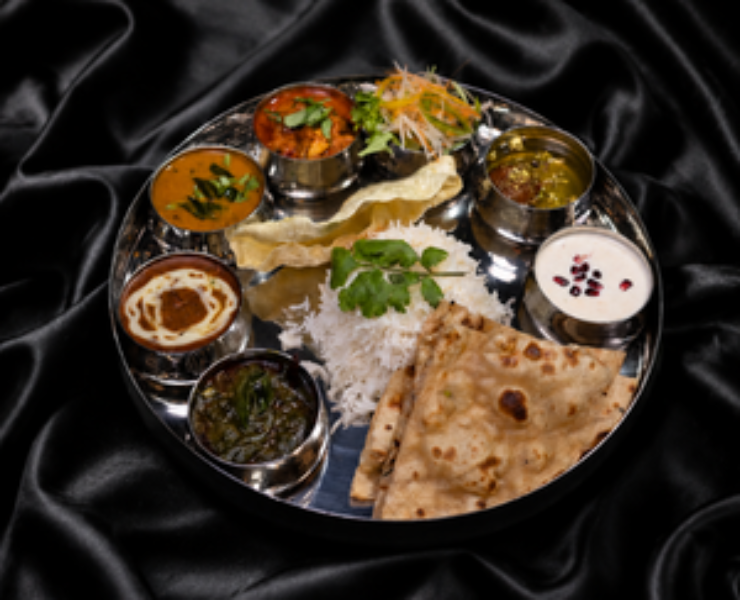 Family-style Indian feast with biryani and curries