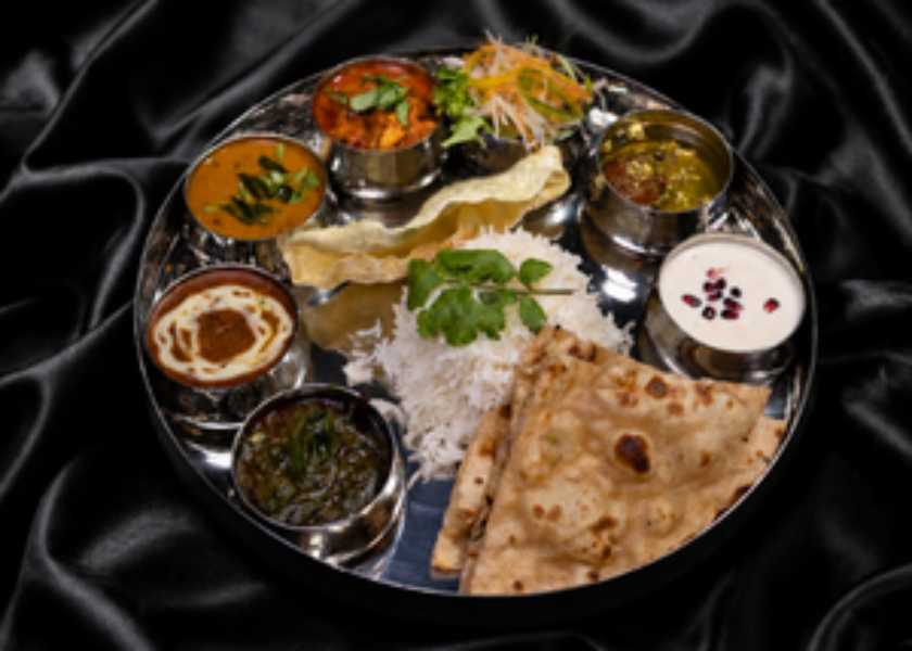 Family-style Indian feast with biryani and curries